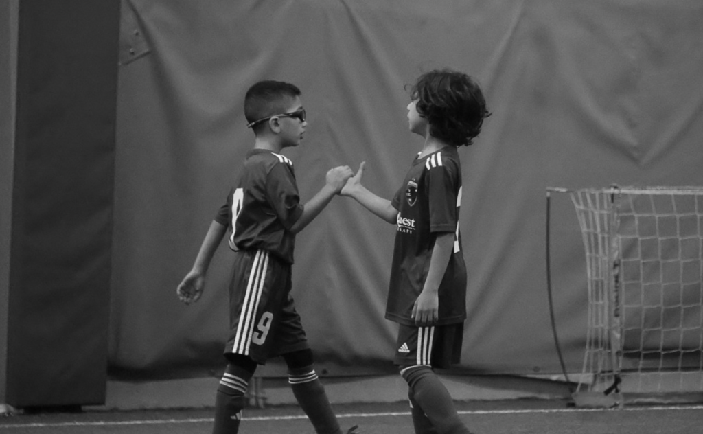 Two kids shaking hands